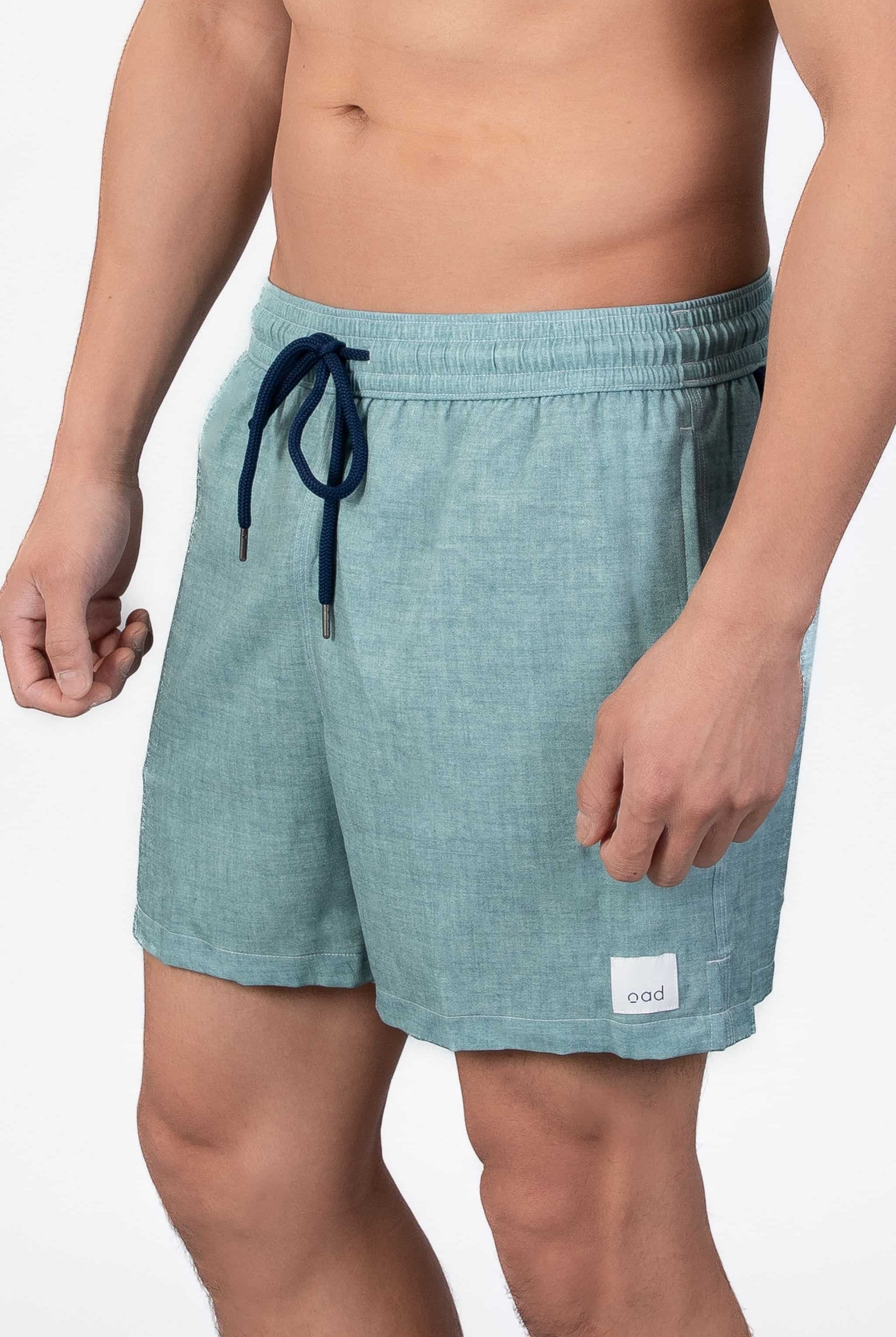 Comfortable, soft aqua blue lounge swim shorts shown from the side, with an elastic waistband