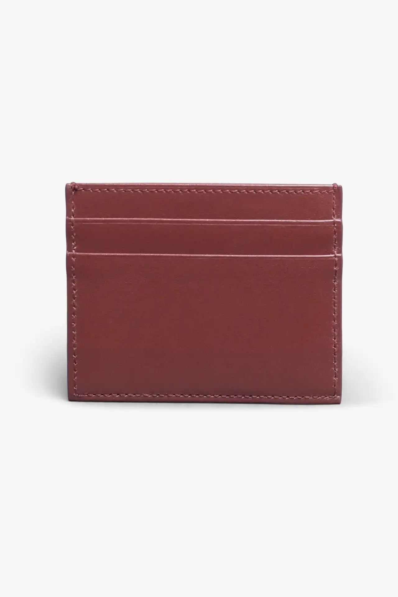 Brown card holder in vegetable tanned leather with a light gray background