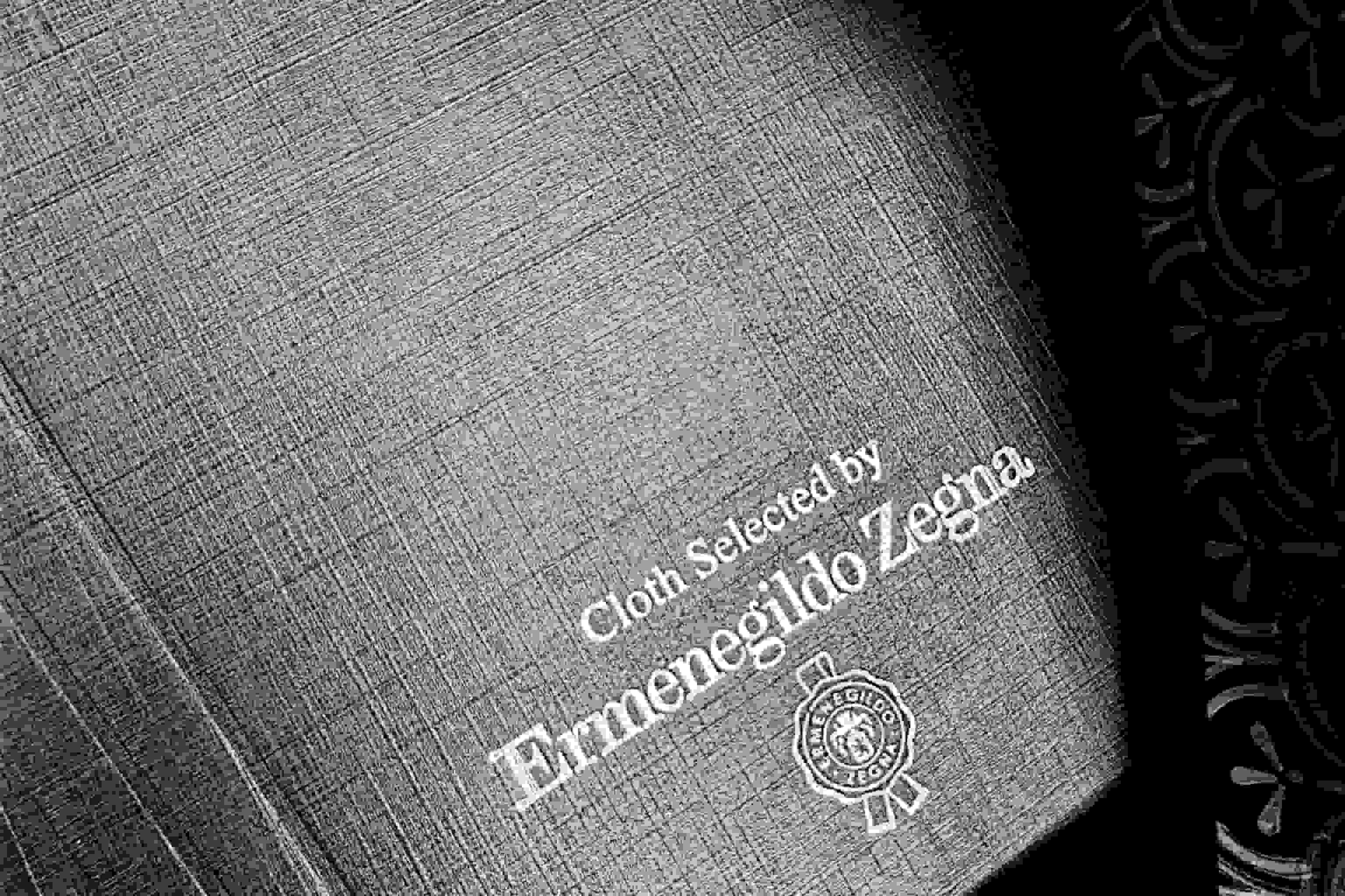 Gray fabric book with 'Ermenegildo Zegna' branding on a dark background