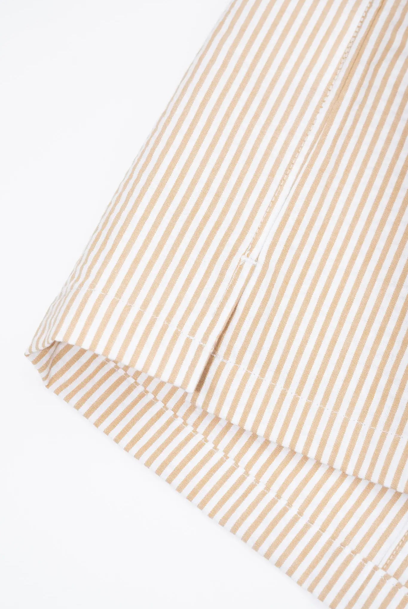 Close-up of a side slit on a striped shirt
