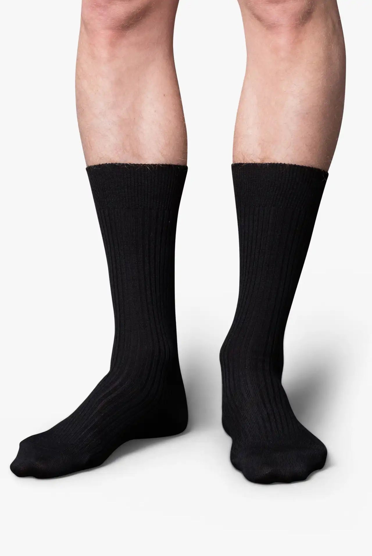 Black dress socks in merino wool. Swedish design by once a day and produced by glenn clyde. Can we washed in warm water without shrinking.