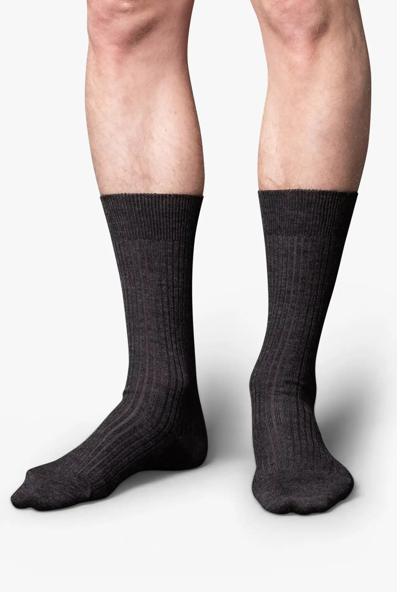 Dark gray melange dress socks in merino wool. Swedish design by once a day and produced by glenn clyde. Can we washed in warm water without shrinking.