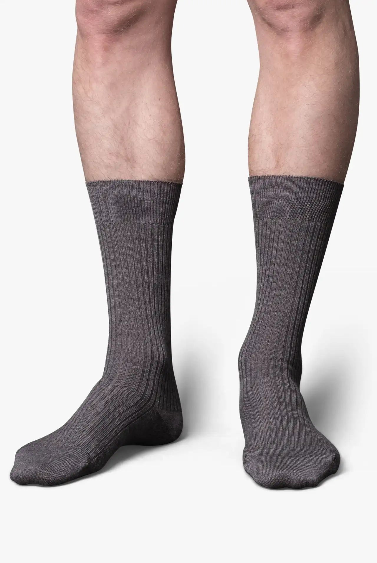 Gray dress socks in merino wool. Swedish design by once a day and produced by glenn clyde. Can we washed in warm water without shrinking.
