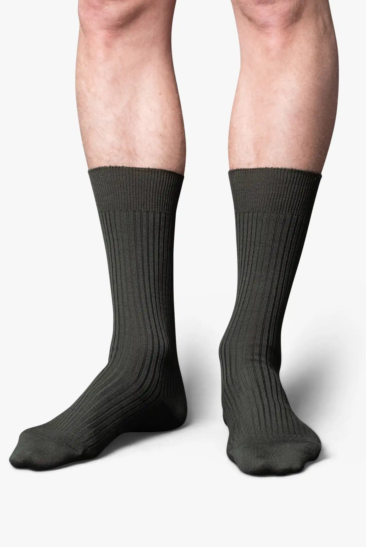 Green dress socks in merino wool. Swedish design by once a day and produced by glenn clyde. Can we washed in warm water without shrinking.