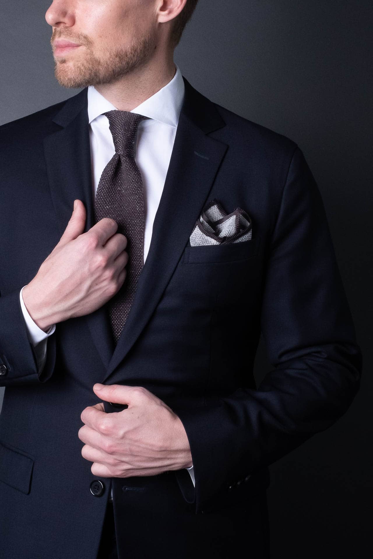 Gray knitted pocket square with gray boarder. Made of silk in Italy paired with Matching tie.