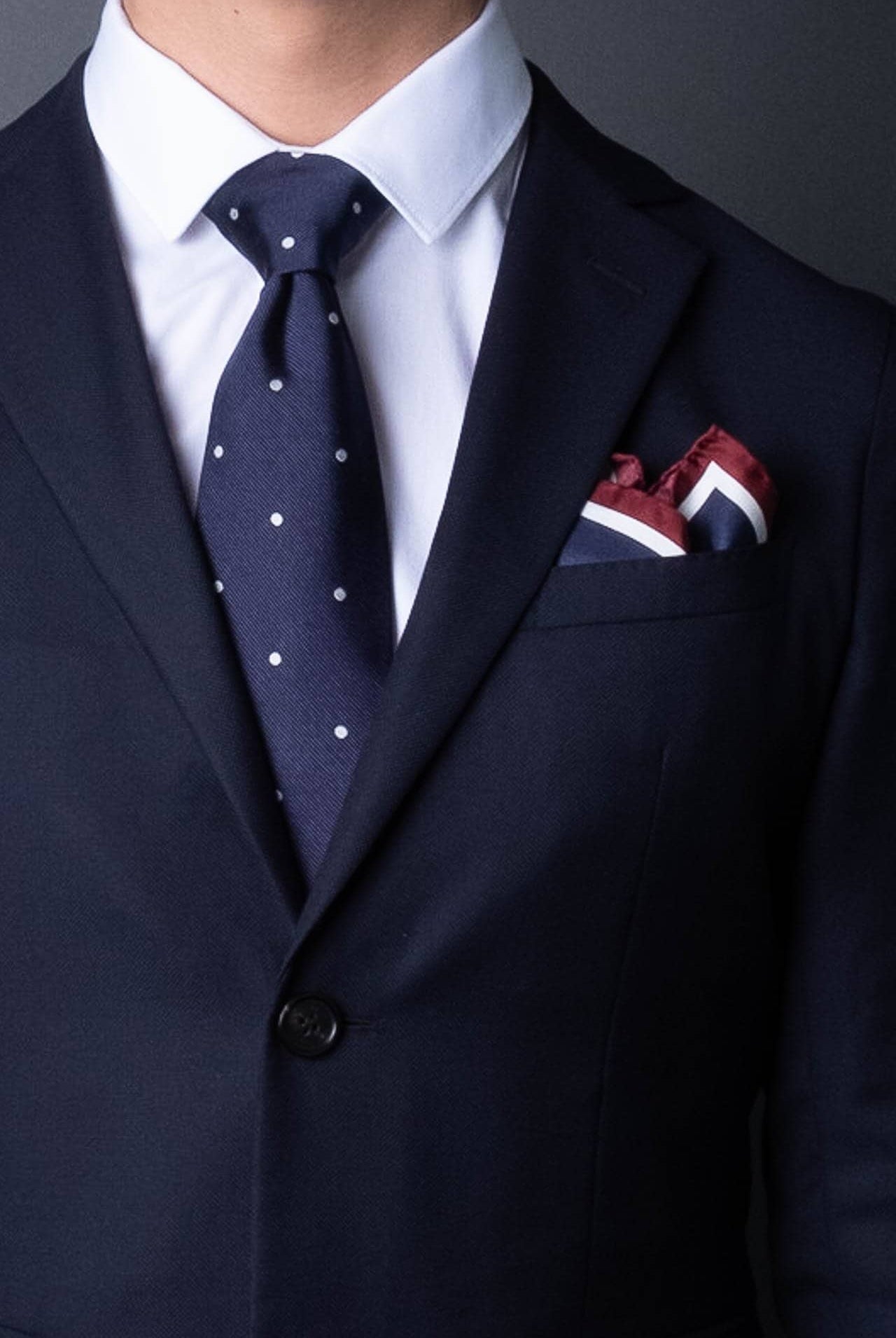 Stockholm motive pocket square in silk, paired with blue ties with polka dots