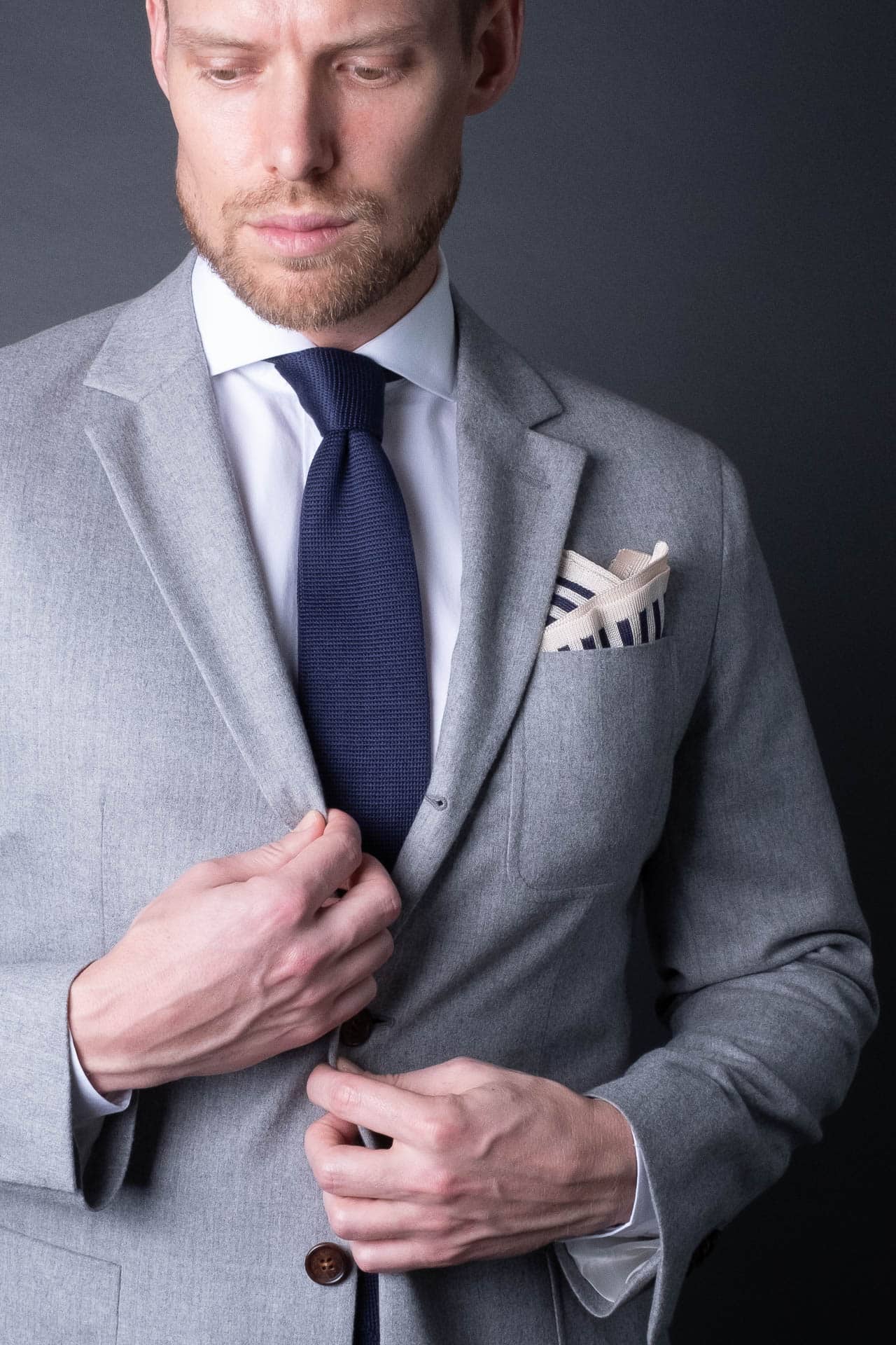 Navy blue and white striped knitted silk pocket square. Made in Italy paired with Matching tie.