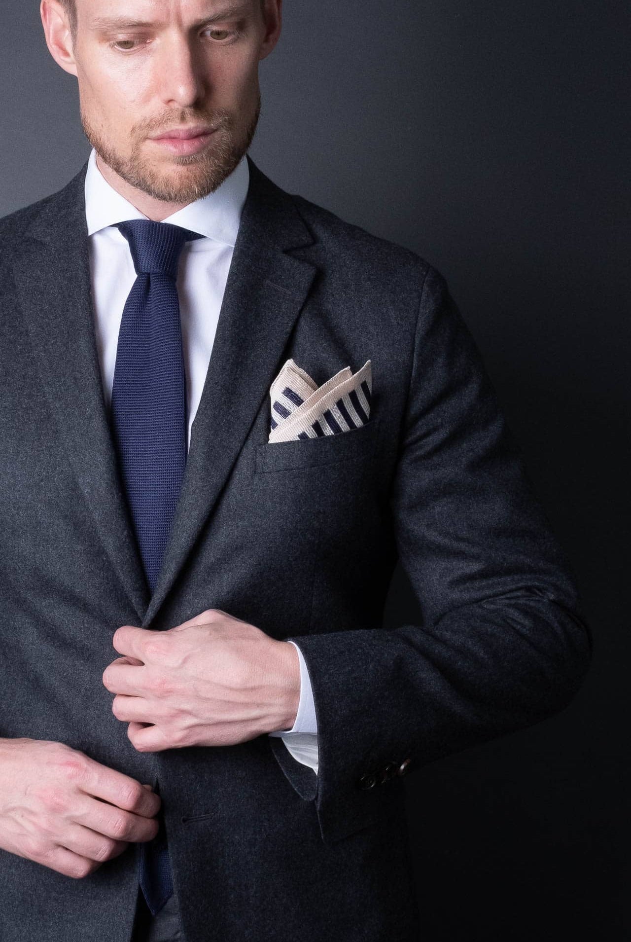 Navy blue and white striped knitted silk pocket square. Made in Italy paired with Matching tie.
