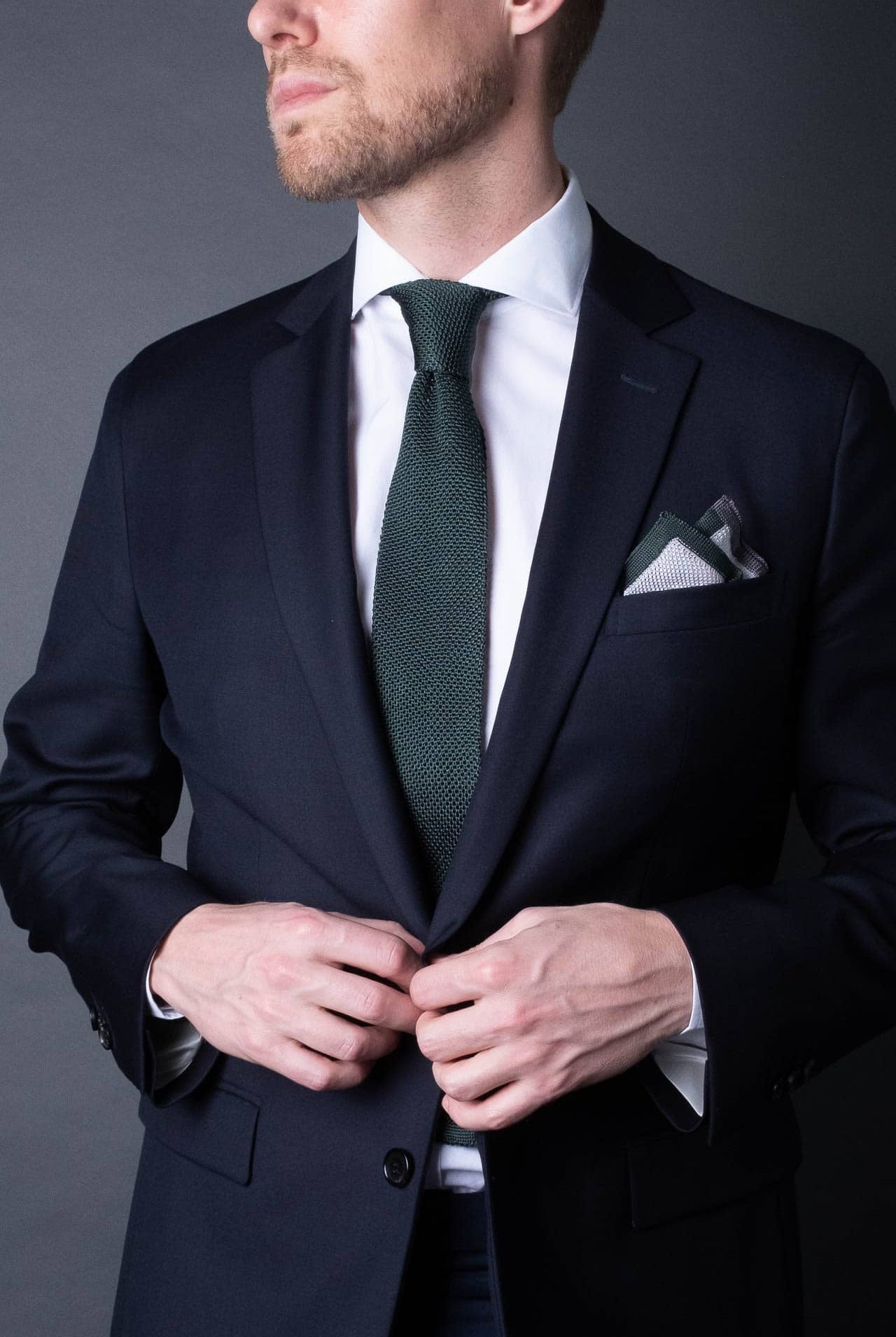 White pocket square with gray and green boarder. Knitted silk made in Italy with matching tie.