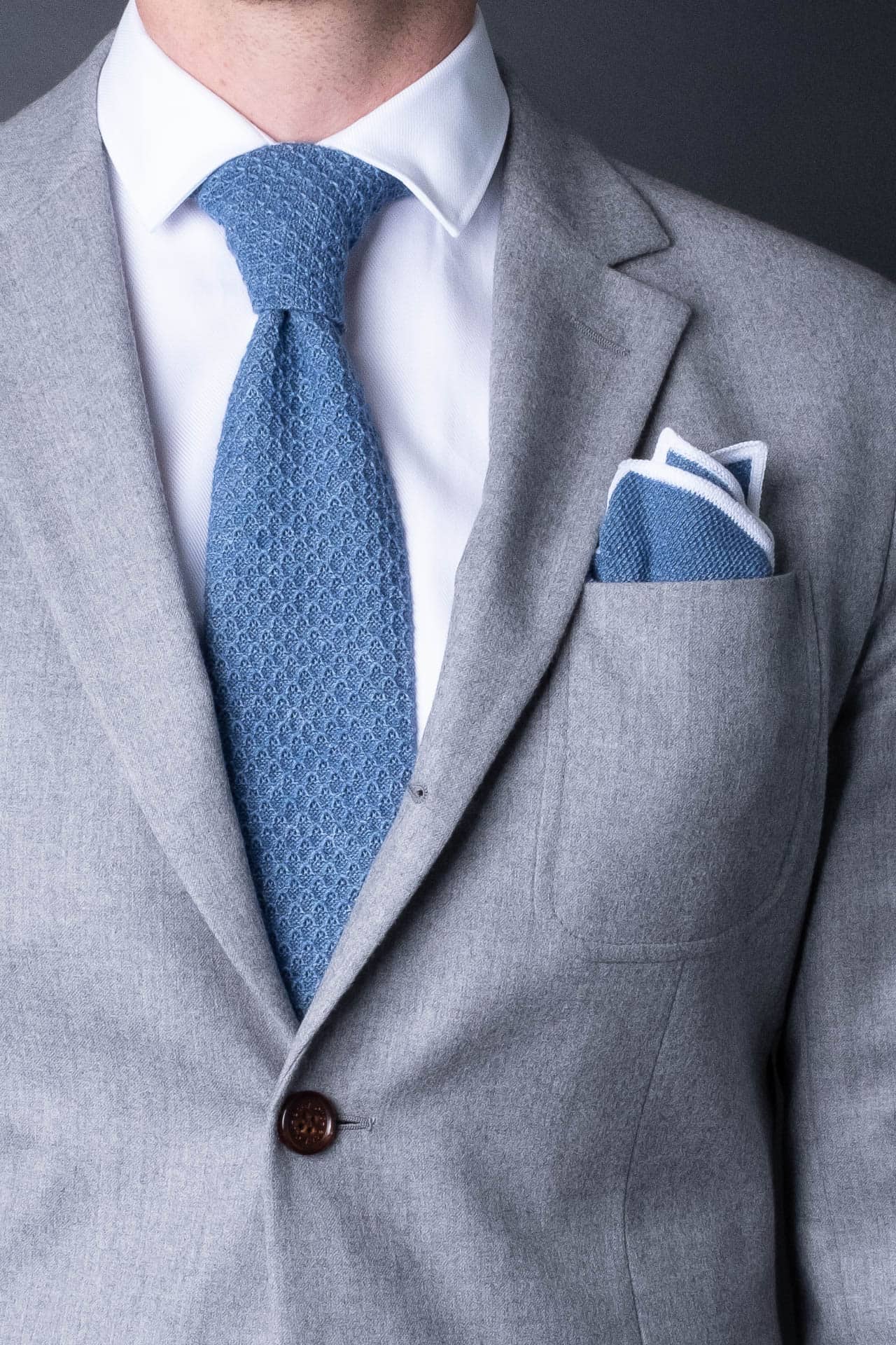 Blue knitted pocket square with white boarder in knitted cotton with matching tie