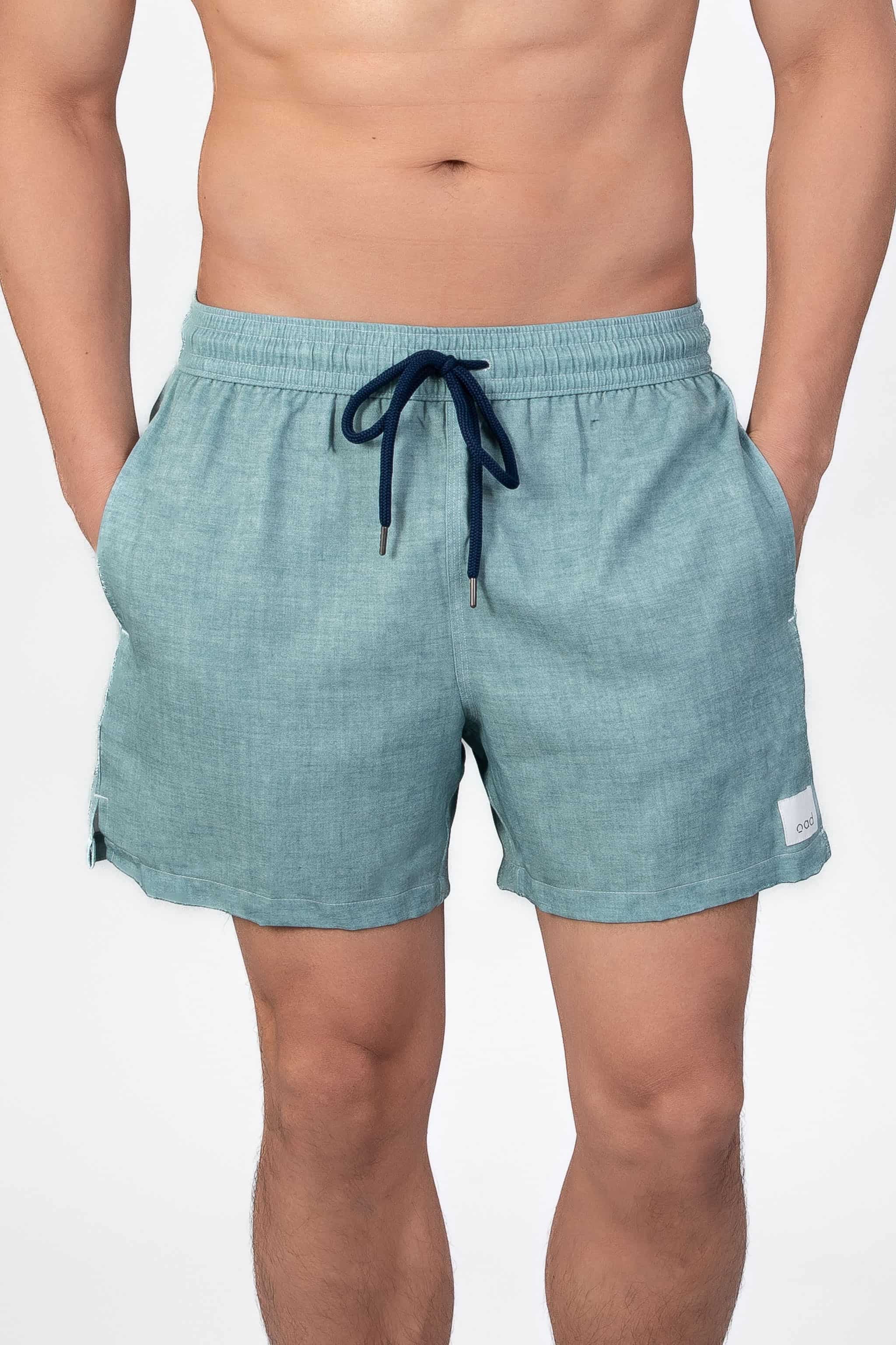 Comfortable, soft aqua blue lounge swim shorts shown from the front, with an elastic waistband
