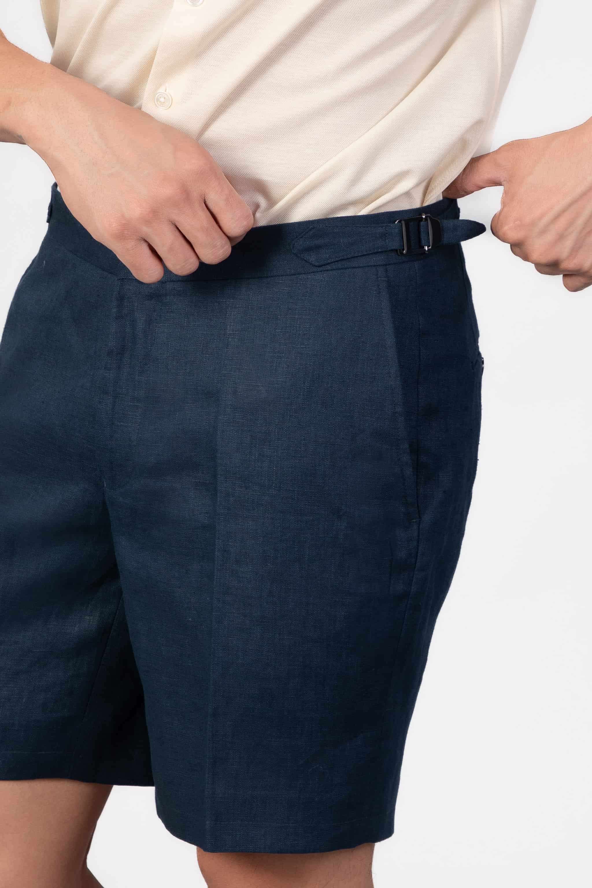 Man wearing navy blue linen shorts with side adjsuters