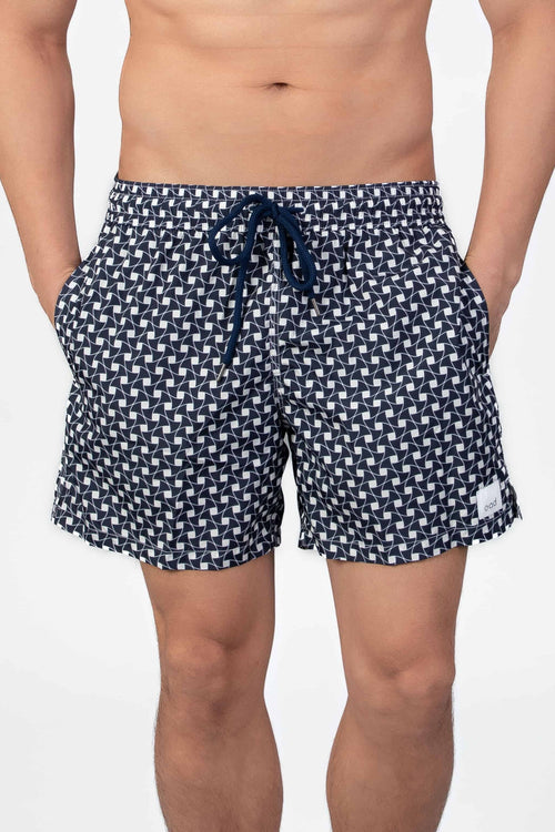 Front view of navy blue swim shorts with a subtle classic pattern and navy string waist closure.