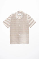 Beige and white striped linen shirt on a white background