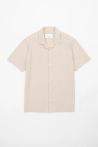 Beige striped camp collar shirt  in seersucker fabric on a white background