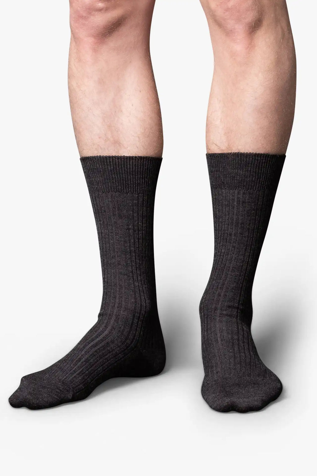 Dark gray melange dress socks in merino wool. Swedish design by once a day and produced by glenn clyde. Can we washed in warm water without shrinking.