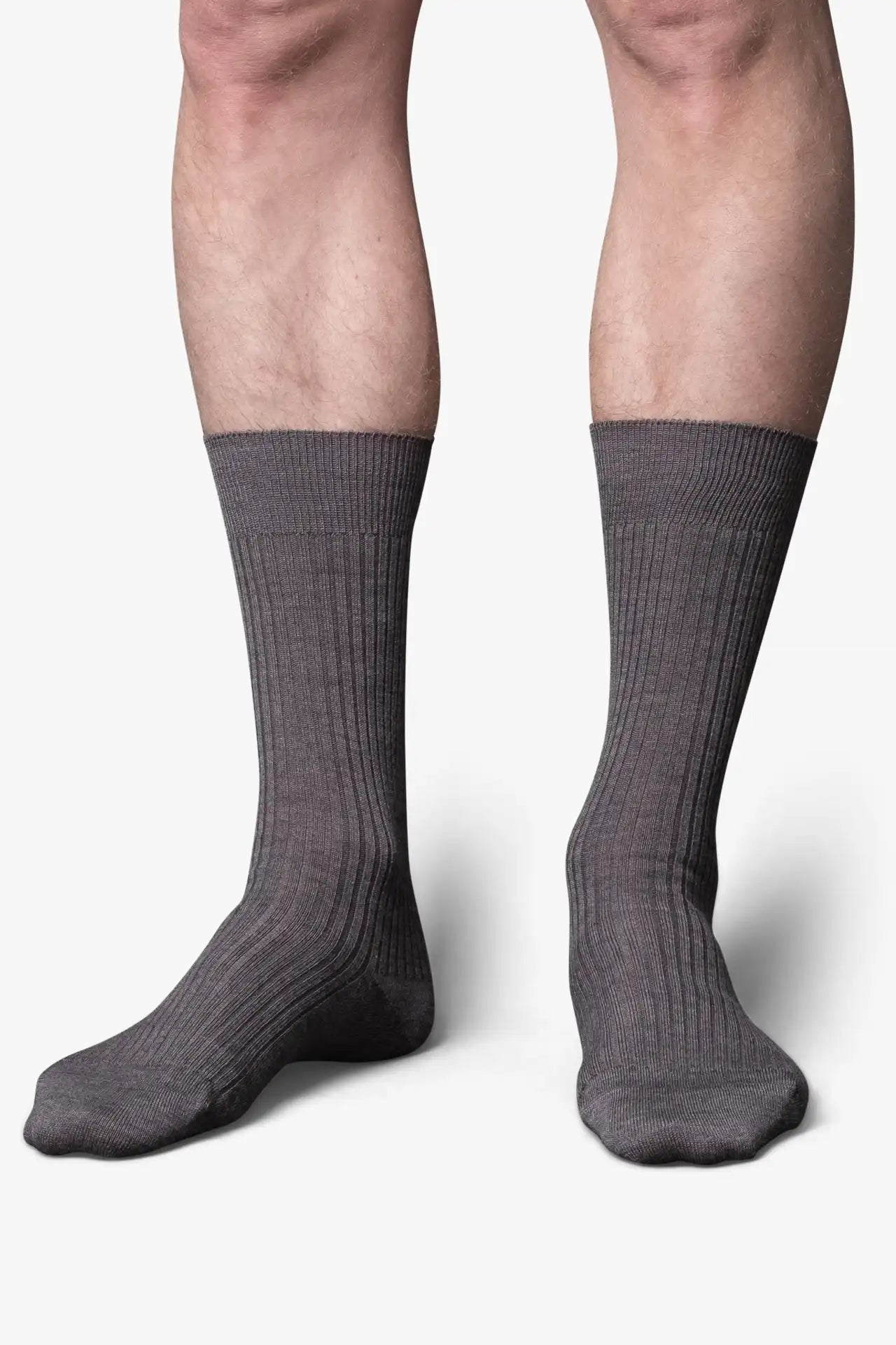 Gray dress socks in merino wool. Swedish design by once a day and produced by glenn clyde. Can we washed in warm water without shrinking.