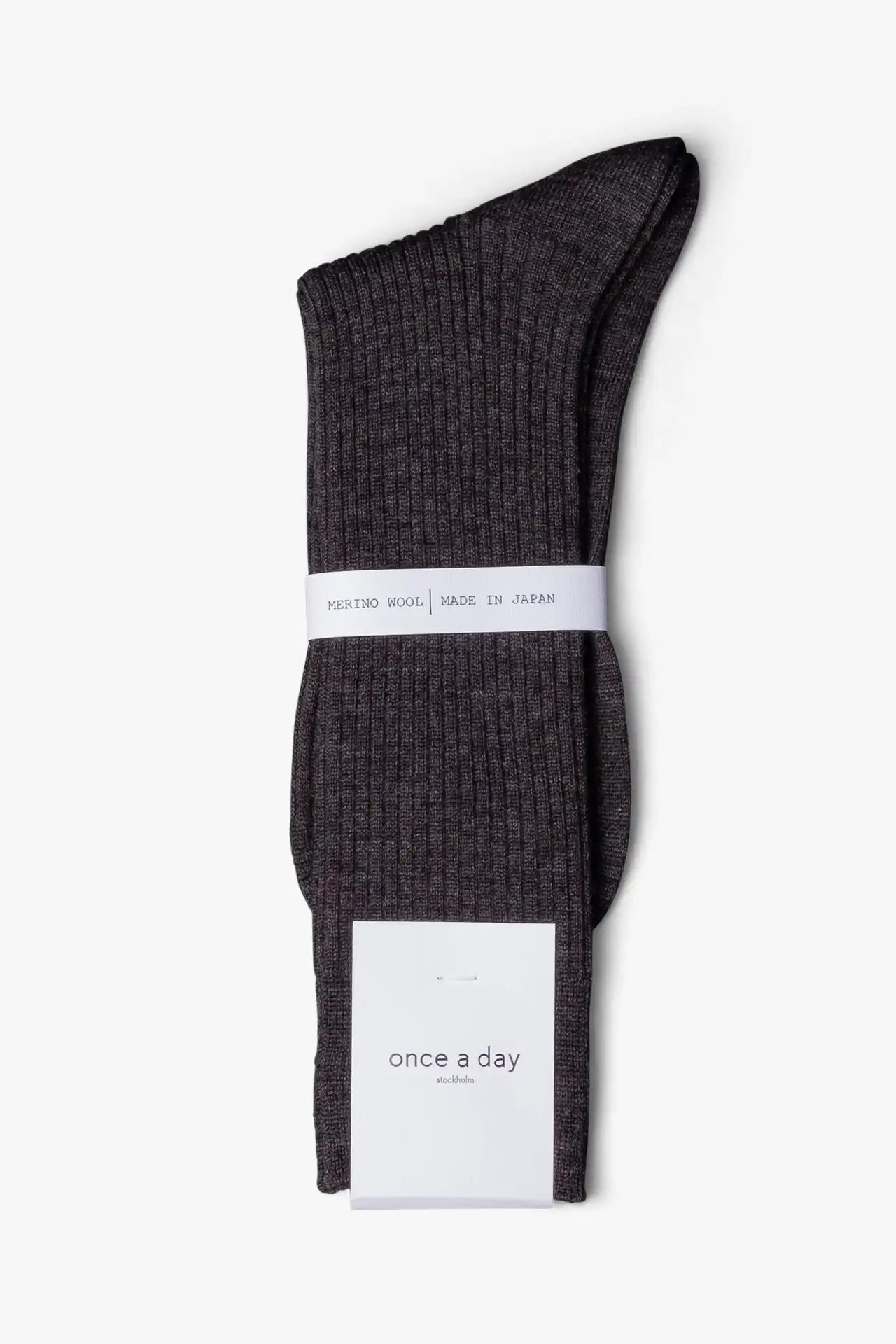 Dark gray melange dress socks in merino wool. Swedish design by once a day and produced by glenn clyde. Can we washed in warm water without shrinking.