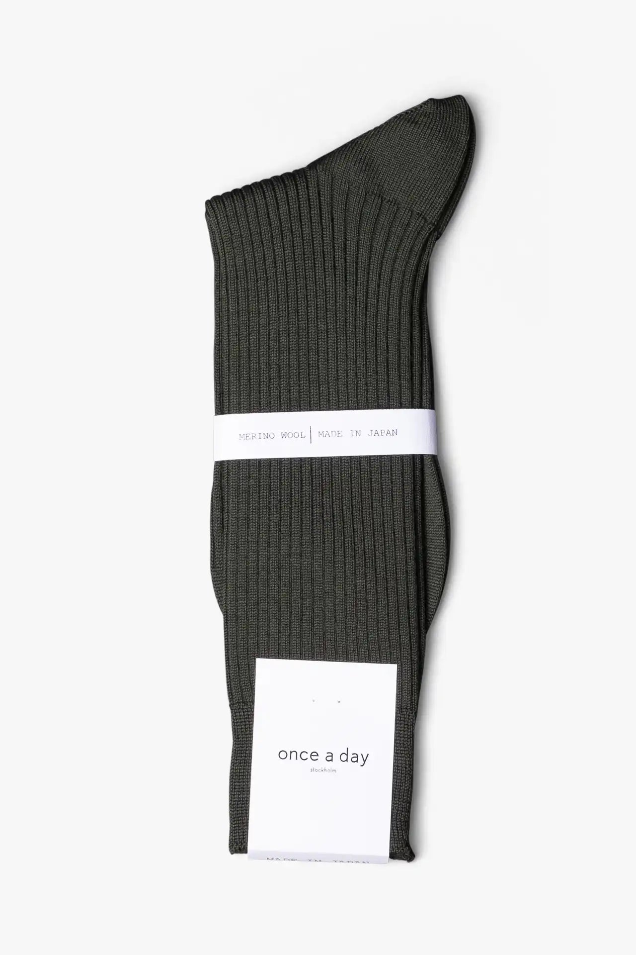 Green dress socks in merino wool. Swedish design by once a day and produced by glenn clyde. Can we washed in warm water without shrinking.