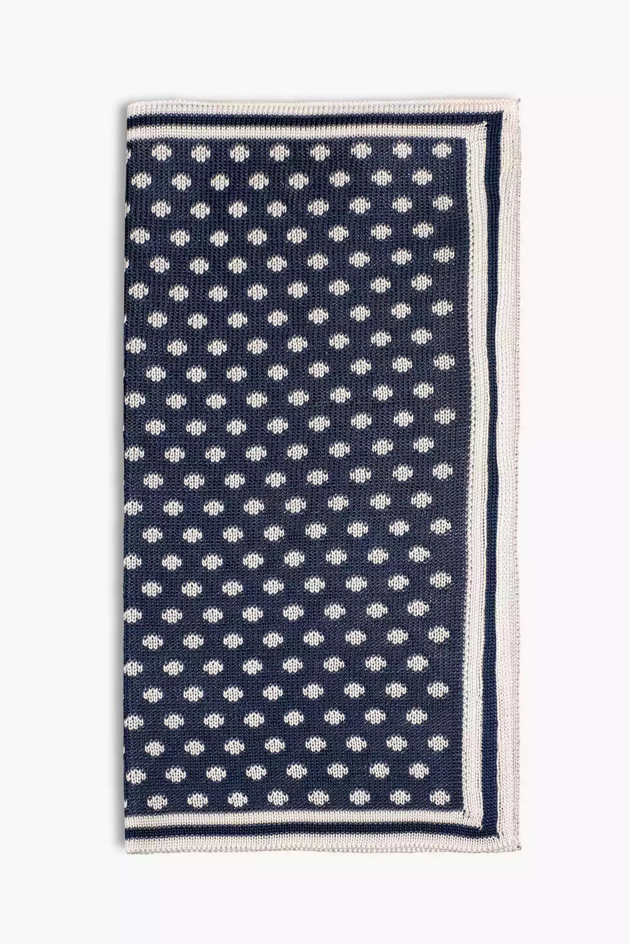 Navy blue knitted pocket square with white dots in knitted silk