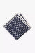 Navy blue knitted pocket square with white dots in knitted silk