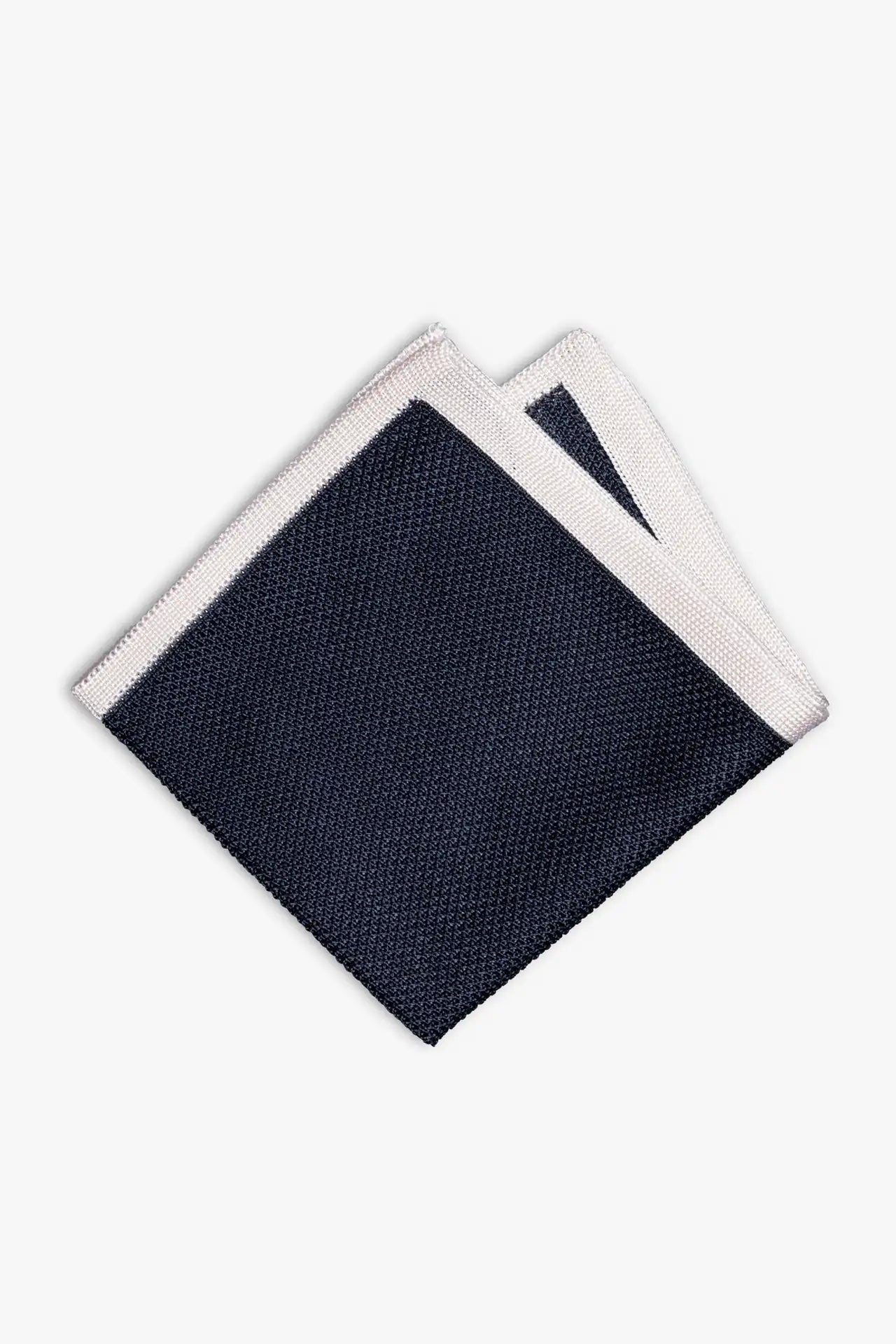 Navy blue knitted pocket square with white boarder. Made of silk in Italy.