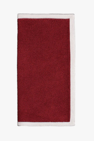 Red knitted pocket square with white frame. Made of silk in Italy.