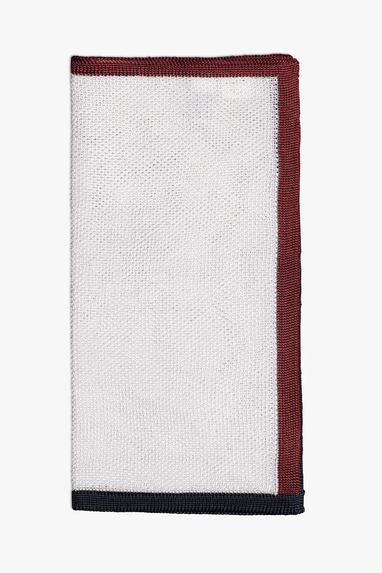 White pocket square with navy blue and red boarder. Knitted silk made in Italy.