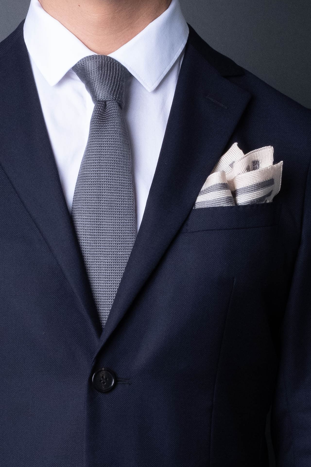 Gray and white striped knitted silk pocket square. Made in Italy.