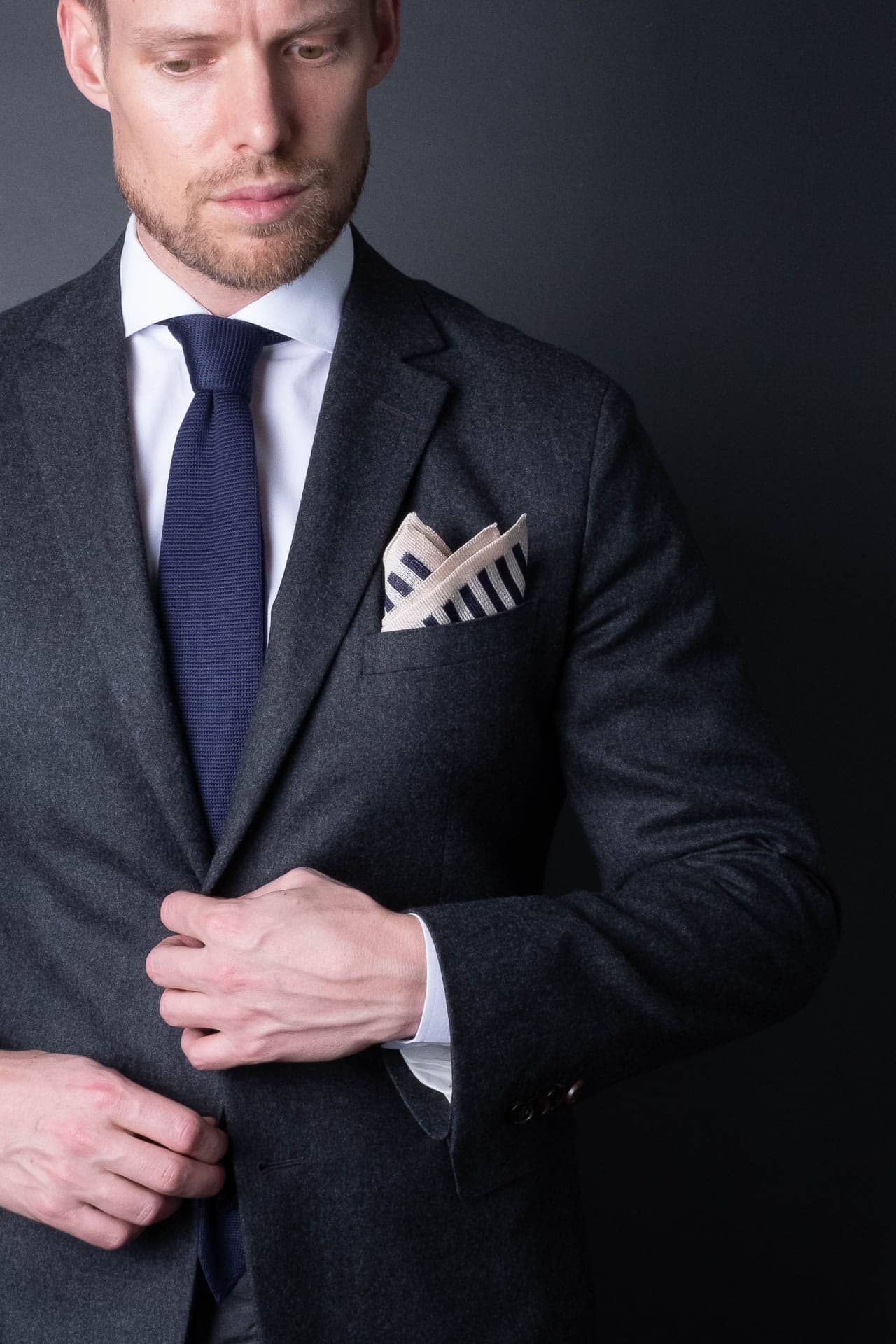 Navy blue and white striped knitted silk pocket square. Made in Italy paired with Matching tie.