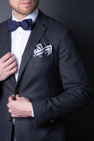 Navy blue knitted pocket square with white dots in knitted silk with matching bow tie