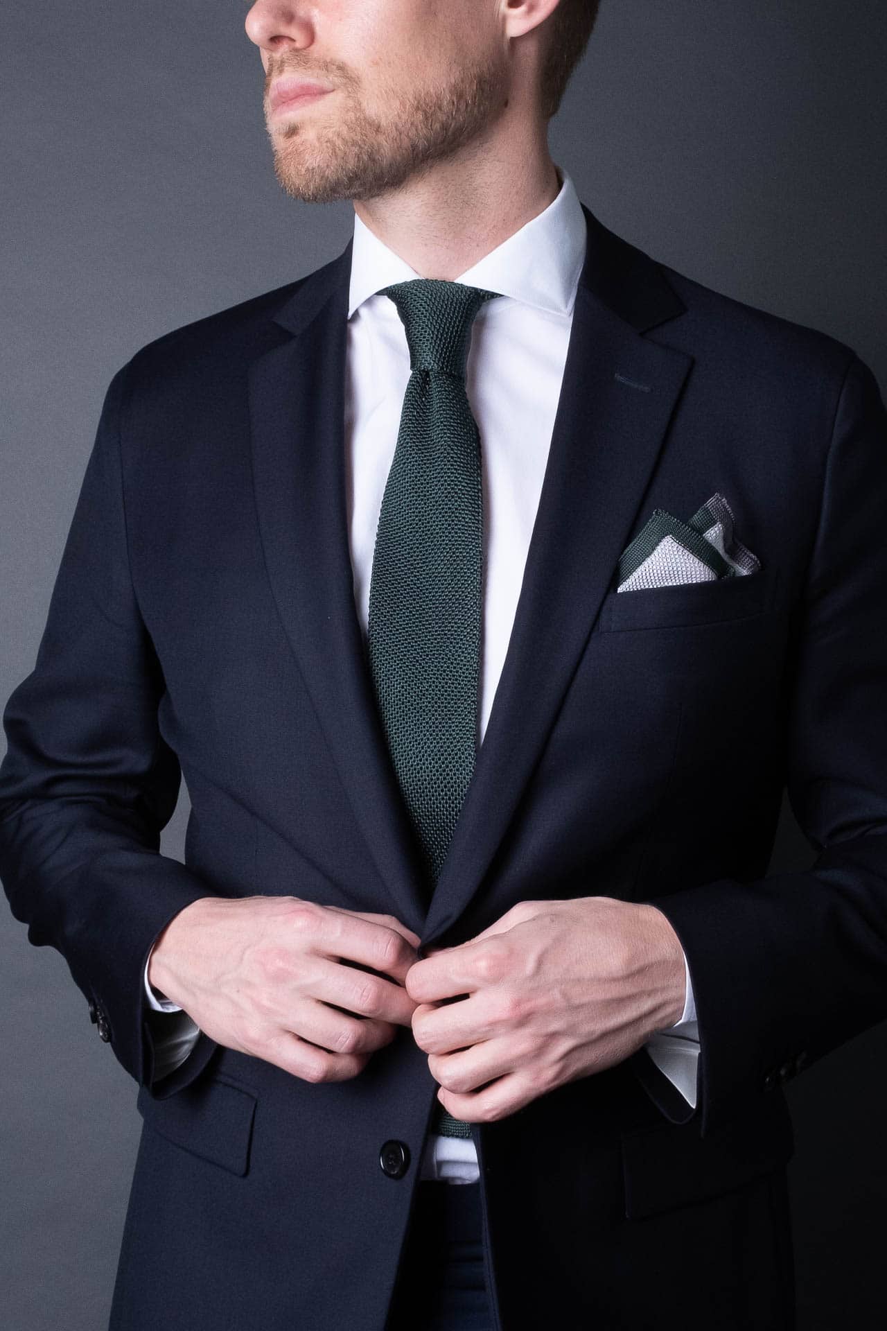 White pocket square with gray and green boarder. Knitted silk made in Italy with matching tie.