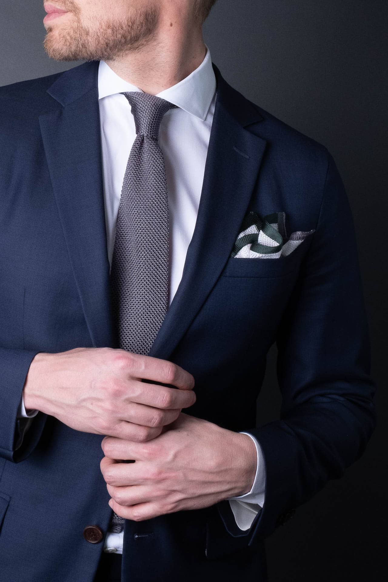 White pocket square with gray and green boarder. Knitted silk made in Italy with matching tie.