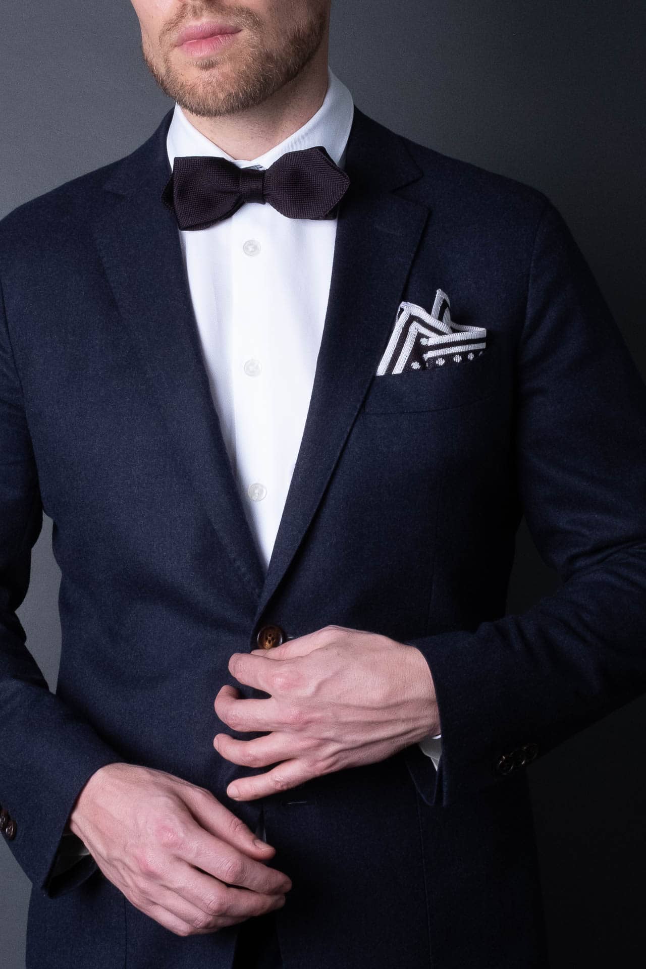 Black knitted pocket square with white dots in knitted silk with matching bow tie
