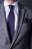 Blue knitted pocket square with navy blue boarder. Made of silk in Italy paired with Matching tie.