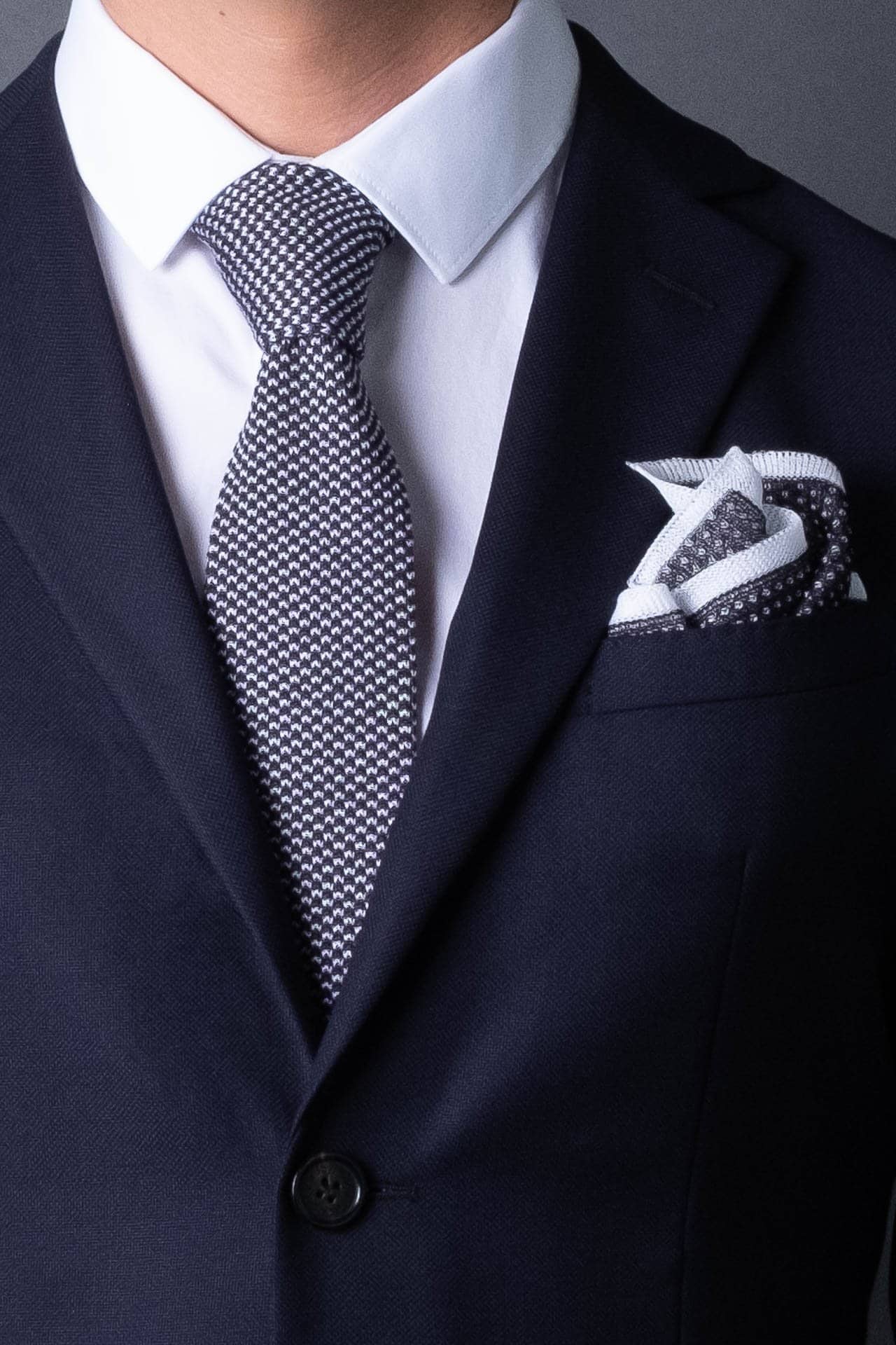 Dark gray and white knitted pocket square with white boarder in cotton with matching tie